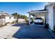 Carport showcasing parking space and view of the gravel area with potted plants at 4010 N Lockwood Ridge Rd, Sarasota, FL 34234