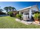 A carport with mature landscaping, providing shade for parked vehicle at 4010 N Lockwood Ridge Rd, Sarasota, FL 34234