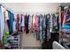 Organized walk-in closet filled with an array of colorful clothing items and storage solutions at 4010 N Lockwood Ridge Rd, Sarasota, FL 34234