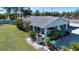 Cozy home featuring a convenient carport and a well-maintained, grassy front yard at 4010 N Lockwood Ridge Rd, Sarasota, FL 34234