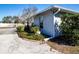 Charming home with well-kept landscaping, framed by lush greenery at 4010 N Lockwood Ridge Rd, Sarasota, FL 34234