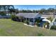 Charming single-story home with a carport, surrounded by a lush green lawn at 4010 N Lockwood Ridge Rd, Sarasota, FL 34234