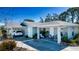 Inviting home featuring a spacious driveway, two carports, and a beautifully landscaped front yard at 4010 N Lockwood Ridge Rd, Sarasota, FL 34234