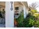 Cozy front porch area featuring outdoor seating surrounded by lush landscaping at 4010 N Lockwood Ridge Rd, Sarasota, FL 34234
