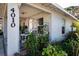 Inviting front porch with seating area surrounded by lush landscaping at 4010 N Lockwood Ridge Rd, Sarasota, FL 34234