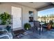 Inviting front porch with seating, plants, and a welcoming entrance mat at 4010 N Lockwood Ridge Rd, Sarasota, FL 34234