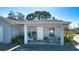 Inviting front porch with seating, plants, and a welcoming entrance to the home at 4010 N Lockwood Ridge Rd, Sarasota, FL 34234