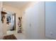 Well-lit hallway with ceramic tile, white cabinets, and view of a room with white sofa at 4010 N Lockwood Ridge Rd, Sarasota, FL 34234