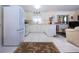 Well-lit kitchen with white cabinetry, modern appliances, and an open layout at 4010 N Lockwood Ridge Rd, Sarasota, FL 34234