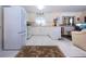 Well-lit kitchen with white cabinetry, modern appliances, and an open layout at 4010 N Lockwood Ridge Rd, Sarasota, FL 34234