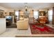 Bright living room featuring a ceiling fan, display shelves, and comfortable seating at 4010 N Lockwood Ridge Rd, Sarasota, FL 34234