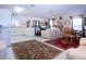 Spacious living room with tile flooring, an adjacent kitchen, and comfortable furnishings at 4010 N Lockwood Ridge Rd, Sarasota, FL 34234