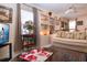 Bright living room with a ceiling fan, display shelves, and comfortable seating at 4010 N Lockwood Ridge Rd, Sarasota, FL 34234