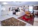 Bright open-concept living room with tile flooring, seamlessly connected to the kitchen at 4010 N Lockwood Ridge Rd, Sarasota, FL 34234