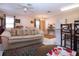 Bright living room featuring a ceiling fan, neutral walls, and kitchen bar at 4010 N Lockwood Ridge Rd, Sarasota, FL 34234