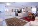 Spacious living room with tile flooring, an adjacent kitchen, and comfortable furnishings at 4010 N Lockwood Ridge Rd, Sarasota, FL 34234