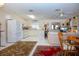 Bright, open living room with white tile, a modern kitchen, and comfortable seating at 4010 N Lockwood Ridge Rd, Sarasota, FL 34234