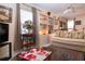 Bright living room with a ceiling fan, display shelves, and comfortable seating at 4010 N Lockwood Ridge Rd, Sarasota, FL 34234