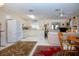 Open living space with combined kitchen and dining, featuring bright white tile flooring at 4010 N Lockwood Ridge Rd, Sarasota, FL 34234