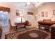 Music room featuring a piano, desk, and decorative rug creating a cozy atmosphere at 4010 N Lockwood Ridge Rd, Sarasota, FL 34234