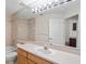 Bathroom with a combined bathtub and shower, light wood cabinets, and a large mirror at 4224 Preserve Pl, Palm Harbor, FL 34685