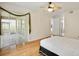Bright bedroom with a ceiling fan, sliding glass doors, and access to an outdoor area at 4224 Preserve Pl, Palm Harbor, FL 34685
