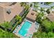Aerial view of a sparkling community pool with lounge chairs and tables at 4224 Preserve Pl, Palm Harbor, FL 34685