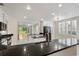 Contemporary kitchen with stainless steel appliances and sleek white cabinets offering generous counter space at 4224 Preserve Pl, Palm Harbor, FL 34685