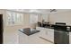 Contemporary kitchen featuring stainless steel appliances, an island, and a cozy breakfast nook at 4224 Preserve Pl, Palm Harbor, FL 34685