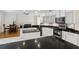 Open-concept kitchen with granite counters, stainless appliances, white cabinets, and an island prep area at 4224 Preserve Pl, Palm Harbor, FL 34685