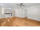 Bright and airy living room featuring hardwood floors, a chandelier, and an open floor plan to the kitchen at 4224 Preserve Pl, Palm Harbor, FL 34685