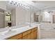 Large main bathroom with dual sinks, soaking tub, and a seamless glass shower at 4224 Preserve Pl, Palm Harbor, FL 34685