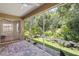 Relax on this screened patio with brick pavers and serene backyard views at 4224 Preserve Pl, Palm Harbor, FL 34685