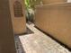 Private side yard area with a stone paver walkway, gated access and a decorative wall trellis at 4224 Preserve Pl, Palm Harbor, FL 34685