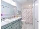 Updated bathroom with marble vanity, decorative mirror, and shower featuring stylish curtain at 4810 Centerbrook Ct, Tampa, FL 33624