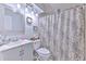 This bathroom features a modern vanity with a mosaic-framed mirror and a stylish shower curtain at 4810 Centerbrook Ct, Tampa, FL 33624