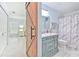 Stylish bathroom featuring a marble vanity, shower/tub and elegant barn door entrance at 4810 Centerbrook Ct, Tampa, FL 33624