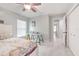 Cozy bedroom offers tiled floors, natural light, and access to ensuite bathroom and closet at 4810 Centerbrook Ct, Tampa, FL 33624