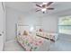 Bright bedroom featuring two twin beds, a ceiling fan, and a window with natural light at 4810 Centerbrook Ct, Tampa, FL 33624