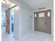 Spacious foyer featuring modern tile flooring, a decorative front door and barn door access to other rooms at 4810 Centerbrook Ct, Tampa, FL 33624