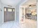 Inviting foyer with decorative front door and a view into the bright office space at 4810 Centerbrook Ct, Tampa, FL 33624