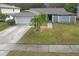 Charming single-story home featuring a two-car garage, well-maintained lawn, and tropical landscaping at 4810 Centerbrook Ct, Tampa, FL 33624