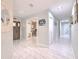 Spacious hallway with modern tile flooring, leading to various rooms, including a home office at 4810 Centerbrook Ct, Tampa, FL 33624