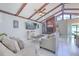 Inviting living room featuring vaulted ceilings, wooden beams, and a cozy fireplace, creating a warm and spacious atmosphere at 4810 Centerbrook Ct, Tampa, FL 33624
