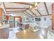 Inviting open-concept with kitchen, living room, dining area under vaulted ceiling with exposed beams at 4810 Centerbrook Ct, Tampa, FL 33624
