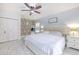 Inviting main bedroom features brick accent wall, ceiling fan and large windows at 4810 Centerbrook Ct, Tampa, FL 33624