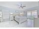 Relaxing bedroom featuring a ceiling fan, sliding glass door and generous natural light at 4810 Centerbrook Ct, Tampa, FL 33624