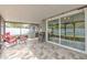 Relaxing screened patio with tile flooring and comfortable seating, perfect for enjoying the outdoors at 4810 Centerbrook Ct, Tampa, FL 33624