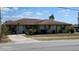 Cozy single-story home featuring a well-maintained lawn, inviting facade, and a concrete driveway at 5507 Riddle Rd, Holiday, FL 34690