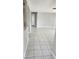 Bright living room with tile flooring, freshly painted walls, and an open layout at 5507 Riddle Rd, Holiday, FL 34690